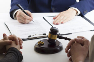 Hands of wife, husband signing decree of divorce